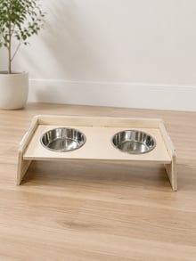 Front angled view of the birch plywood raised dog bowl stand on a timber floor