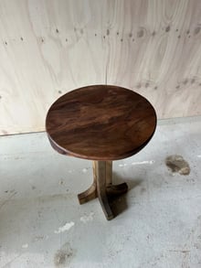 Round walnut side table with a sculptural timber base, made to order in New Zealand