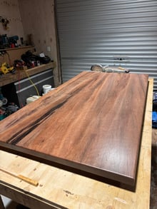 Finished solid timber slab tabletop with a soft eased edge on the workbench in the Design Eye workshop