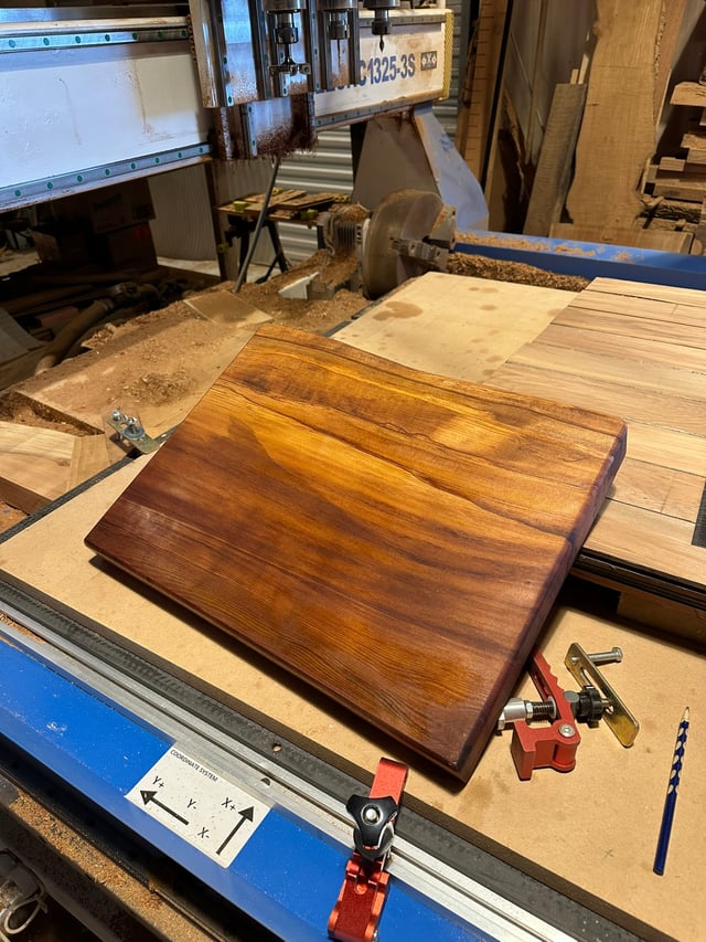 A finished timber board on the CNC bed in the Design Eye workshop