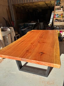 Custom Rimu solid timber slab dining table with a steel base in the Design Eye workshop