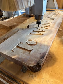 CNC machined wooden property entrance sign being cut in the workshop