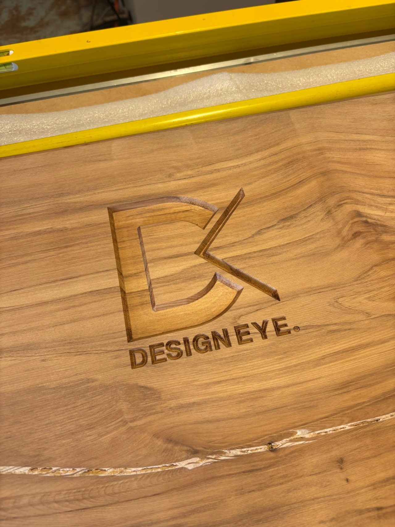 Design Eye logo CNC engraved into a solid timber slab